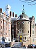 A rounded brick building with windows that look like eyes