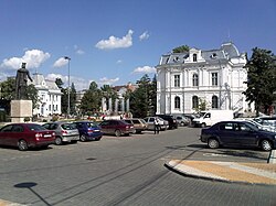 View of the central square with the Art Gallery on the right side of the picture and the City Hall building on the left side.