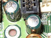 Failed Tayeh capacitors which have vented subtly through their aluminum tops