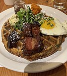 Savory waffle with traditional breakfast toppings.