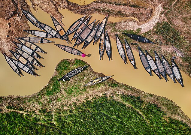 圖為沿着戈沃恩河淡水航道停泊木船的空中景觀，攝於孟加拉錫爾赫特縣戈瓦恩加特的法泰赫普爾村拉塔古爾沼澤林。