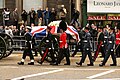 Margaret Thatchers coffin being carried on a gun carriage, and escorted by her pallbearers.