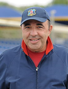 Rabinovich outdoors, in an open-necked shirt