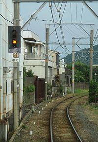 Yellow caution light on left side of track