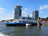 IJ ferry 61 in front of the A'DAM Toren en het Eye Filmmuseum.