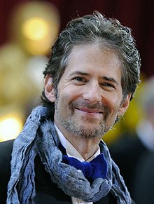 A headshot of a man smiling