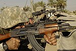 U.S. Army Soldier from the 1st Stryker Brigade Combat Team return fire on insurgents from a rooftop in Buhriz, Iraq