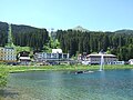 A view of the railway station, with the Obersee in the foreground and the cable car behind