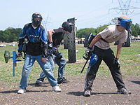 A paintball team prepares to breakout.