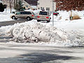 A large amount of snow moved off of a road by snow plow in Northern Virginia