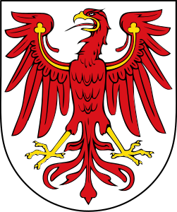 Argent, an eagle displayed gules armed and wings charged with trefoils Or. Arms of Brandenburg.