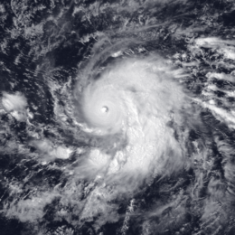 Satellite image of a large, mature hurricane. The structure of the storm is similar to the number "9", with a single, large rainband curving into the center. At the center, there is a small, well-defined eye.