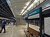 Picture of Macquarie University station. It consists of an underground platform with platform screen doors and a curved roof, similar to Macquarie Park station.