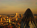 Upper portion of the building with the skyscrapers of Canary Wharf in the background