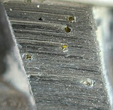 A polished metal blade embedded with small diamonds