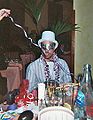 Young man wears a party top hat at a New Year's Party.