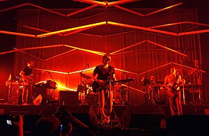 Atoms for Peace performing in 2010. From left to right: Nigel Godrich, Thom Yorke, Flea, and Mauro Refosco (little obscured behind Flea, Joey Waronker obscured behind the drums)