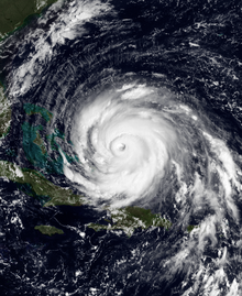 A view of Hurricane Floyd from Space on September 13, 1999. The storm is mature and well-defined, with a pronounced eye feature. Floyd is located over the Atlantic Ocean, and to the north and east of Cuba and Florida, respectively.