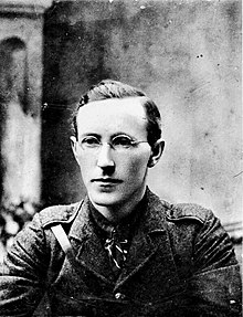 "Black and white photograph of Liam Lynch, the IRA Chief of Staff; it shows a man with short, parted hair and glasses, attired in a military jacket and wearing a tie"