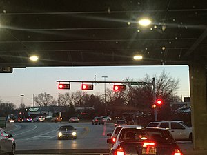 Three horizontally mounted traffic lights for visibility under a bridge in King of Prussia, Pennsylvania. Pennsylvania typically mounts traffic lights vertically.