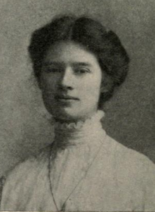 A young white woman with dark hair in an updo