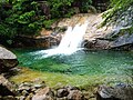 A colorful pond at the Nine Dragon Waterfall scenic area at the foot of the mountain