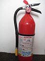 A typical dry chemical extinguisher containing 5 lbs. of ammonium phosphate dry chemical.