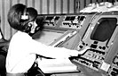 Biomedical Engineer Judy Sullivan wearing a headset at her console during training for the Apollo 11 mission.