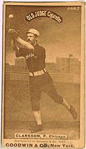 A baseball player is shown attempting to catch a baseball.