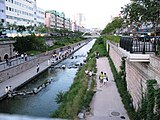 A long park runs on both sides of the stream.