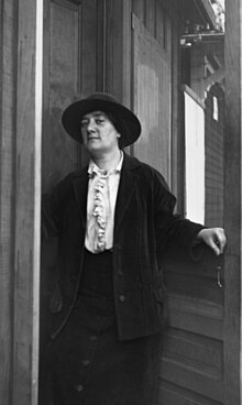 Black and white photograph of Margaret Turnbull, standing in a door way.