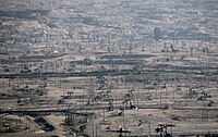 The densely developed Kern River Oil Field, California: Hundreds of pumpjacks are visible in the full-size view. This style of development was common in the oil booms of the early 20th century.