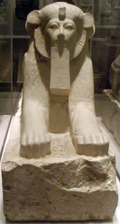 Sphinx of Hatshepsut with unusual rounded ears and ruff that stress the lioness features of the statue, but with five toes – newel post decorations from the lower ramp of her tomb complex. The statue incorporated the nemes headcloth and a royal beard; two defining characteristics of an Egyptian pharaoh. It was placed along with others in Hatshepsut's mortuary temple at Deir el-Bahri. Thutmose III later on destroyed them but they were reassembled by the Metropolitan Museum of Art. Date: 1479–1458 BC. Period: New Kingdom. 18th Dynasty. Medium: Granite, paint.[57]