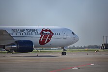 The band's plane in Amsterdam in October 2017; it has the band's tongue logo painted on the side.