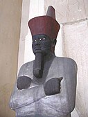 An Osiride statue of the first pharaoh of the Middle Kingdom, Mentuhotep II; 2061–2010 BC; painted sandstone; 138 × 47 cm; Egyptian Museum (Cairo)