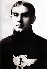 Black and white photo of a man aged 21 years, wearing a dark-coloured hockey sweater