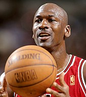 Head shot of a bald black man looking left