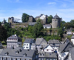 Slate-roofs of Monschau town centre and castle. The castle's courtyard in preparation for Monschau Open Air Klassik music festival