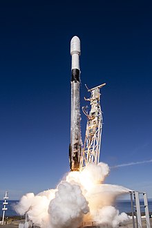 Ground-level view of a Falcon 9 lifting off from its launch pad