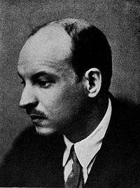 Monochrome head and shoulders portrait of a man, about 45, slightly bald with a mustache, wearing a jacket, white shirt, and tie