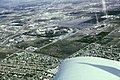 Aerial photo of Disneyland and the surrounding area, including the Disneyland Hotel with its Monorail Station, the Disneyland Heliport, orange groves, Santa Ana Freeway and Melodyland Theater, May 1965