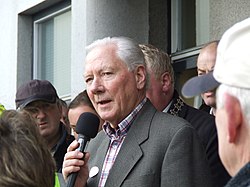 Gay Byrne speaking into a microphone in 2008