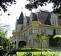 Châteauesque Kimberly Crest home viewed from road.