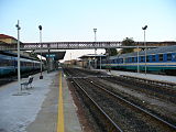 Passenger service tracks with historic iron bridge.