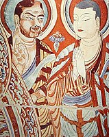 A blue-eyed Central Asian monk teaching an East-Asian monk, Bezeklik, Turfan, eastern Tarim Basin, China, 9th century; the monk on the right is possibly Tocharian,[147] although more likely Sogdian.[148][149]