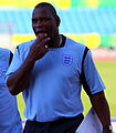 Heavily built middle-aged black man wearing an England football shirt