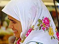 A woman wearing a headscarf in the 'babooska' style, in Kalkan, Turkey.