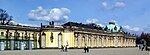 Single story pale yellow ornate palace stretching from the left foreground to the right background.