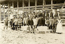 1913 Staff at the Neuohe factory, with workers and a female cook in front of a drying shed