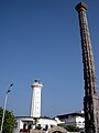 Old Light House and one of the pillars which were brought from Gingee Fort and installed around the Gandhi Statue on the beach